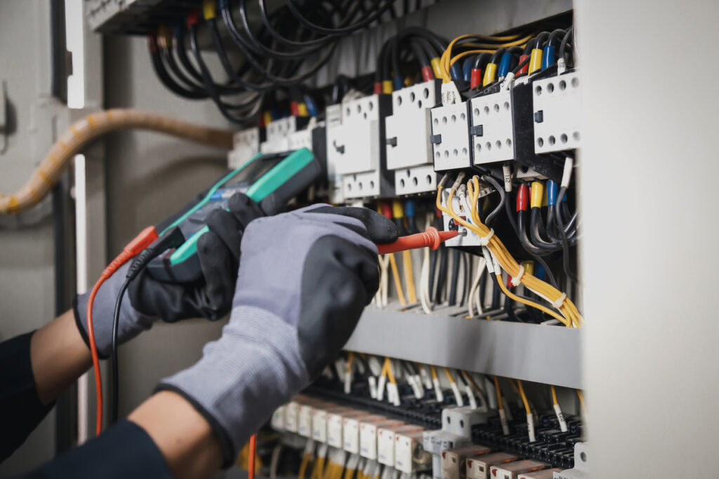 Rolwes Electric technician testing a generator transfer switch at a Warren County, MO business